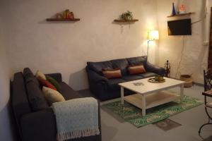 sala de estar con sofá y mesa en Eco Holidays Cave House Justine, en Granadilla de Abona
