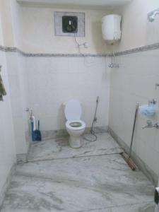 a white bathroom with a toilet in a room at B&B Homestay in Darjeeling