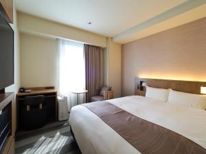 Postel nebo postele na pokoji v ubytování Far East Village Hotel Yokohama