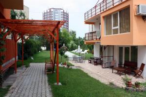 a patio in the middle of a building with benches at Vila Bucura 19 in Venus