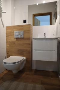 a bathroom with a toilet and a sink at FraToLe in Nielisz