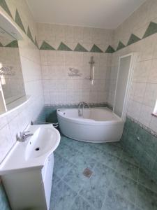 a bathroom with a bath tub and a sink at Apartment in Lopar with sea view, terrace, air conditioning, Wi-Fi (4618-2) in Lopar