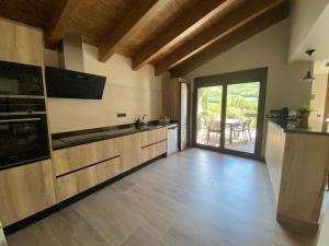 a large kitchen with wooden floors and a large window at Casa La Pedrana in Chía