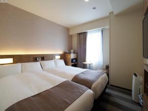 Postel nebo postele na pokoji v ubytování Far East Village Hotel Yokohama