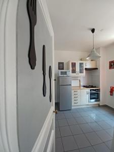 a kitchen with a fork and knife on the door at THE WHITE & RED HOUSE in Meaux