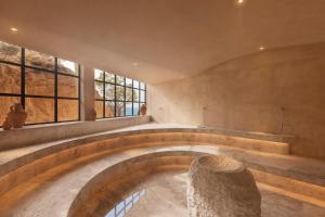 a circular room with a stone bowl in the middle at Six Senses Ibiza in Portinatx