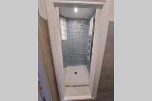 uma casa de banho com uma cabina de duche ao nível do chão ao lado de uma cabina de duche ao nível do chão em Les clématites em Narbona