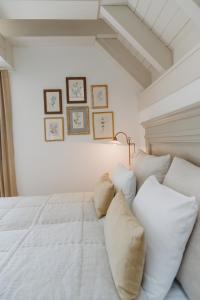 a bedroom with a white bed with white pillows at Ráj na zemi venkovský hotel a kavárna in Hukvaldy