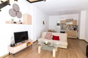 a living room with a couch and a tv at ARGY’S HOME in Alexandroupoli