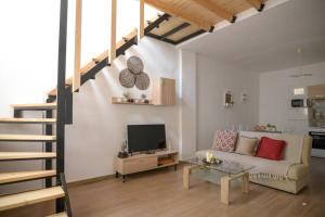 a living room with a couch and a television at ARGY’S HOME in Alexandroupoli