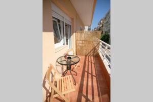 a patio with a table and two chairs on a balcony at ARGY’S HOME in Alexandroupoli