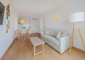 a living room with a couch and a table at Club Simó in Cala Millor