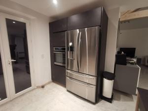 a large stainless steel refrigerator in a kitchen at Villa beaupré les Issambres Roquebrune sur argens, frejus in Les Issambres