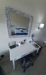 a white desk with a mirror on a wall at Blue views at Brookes Hill Suites in Port Elizabeth