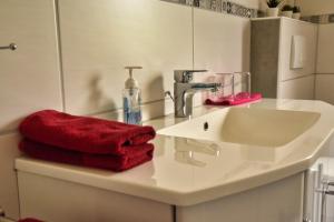 a bathroom with a sink and a red towel at Ferienwohnung Landsknecht in Volkach