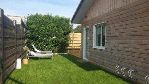 a small yard with a bench next to a house at COSY T3 LACANAU in Lacanau