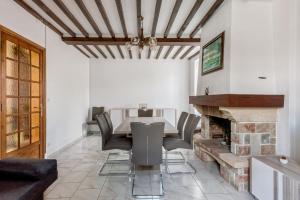 a dining room with a table and chairs and a fireplace at Hamo - Maison à 600 m de la plage in Graye-sur-Mer