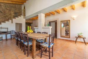 a kitchen and dining room with a wooden table and chairs at Lo den Creus in Campos