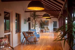 a living room with pendant lights and a table and chairs at Elma Guesthouse in Alba Iulia