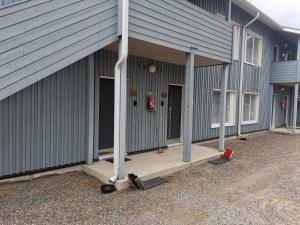 an outside view of a building with a garage at Ylläs Kanerva 102 in Äkäslompolo