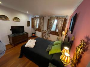 a bedroom with a bed and a flat screen tv at Hotel Boutique La Llave de la Judería in Córdoba
