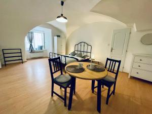 a room with a table and chairs and a bed at Studio Nicolas II Prague in Prague +4 photos