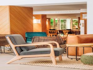 a group of chairs and tables in a store at ibis Styles Golden Sands Roomer Hotel in Golden Sands
