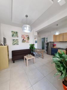 a living room with a couch and a table at Harmony Residence in Kavos