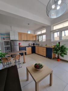 a large kitchen with a table in the middle at Harmony Residence in Kavos