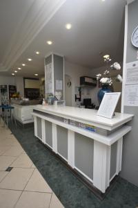 a large white counter in a room with a pharmacy at Lively Hotel in Bellaria-Igea Marina