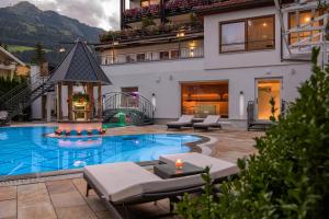 a house with a swimming pool in a yard at Hotel Bismarck in Bad Hofgastein