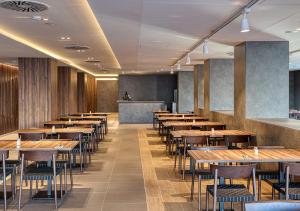 a row of tables and chairs in a restaurant at Senator Gandia in Gandía