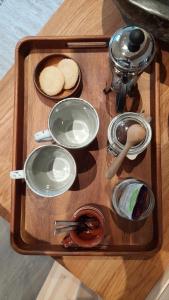 a tray with plates and utensils on a table at Trasti & Trine Boutique Hotel in Alta
