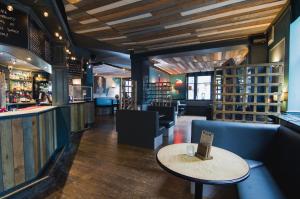 a restaurant with a table and chairs and a bar at The Royal Hotel and Bar in Lancaster