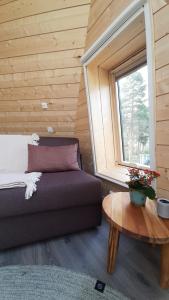 a bedroom with a bed and a table and a window at Trasti & Trine Boutique Hotel in Alta