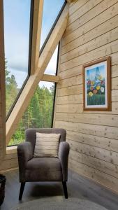 a chair in a room with a wooden wall at Trasti & Trine Boutique Hotel in Alta