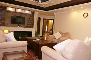 a living room with two couches and a coffee table at Luxury 3 Bedrooms Apartment in Lahore