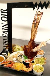 a tray filled with seafood and other foods at Caisleain Oir Hotel in Annagry