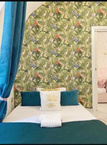 a bedroom with a wall with a bird wallpaper at Domus Leone Tre in Naples