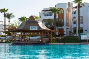 a swimming pool with a gazebo next to a hotel at Sunrise Remal Resort in Sharm El Sheikh