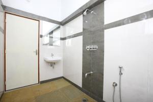 a bathroom with a shower and a sink at Hotel Du Palais - Auroville Beach in Pondicherry