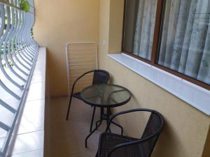 a table and two chairs in a room with a window at Студио Булаир 1 in Burgas City