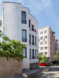 a white building on the side of a street at Hotel "Elesa Wera" in Tbilisi City