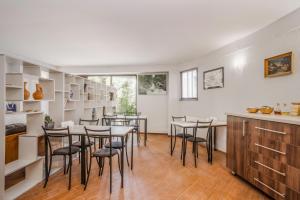 a kitchen and dining room with tables and chairs at Hotel "Elesa Wera" in Tbilisi City