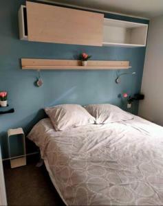 昂布朗的住宿－Mobil home 6 places，一间卧室配有一张蓝色墙壁的床