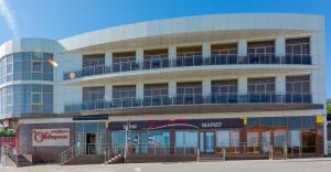 a large building with a balcony on top of it at Panorama Hotel in Vityazevo