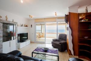 a living room with a view of the ocean at Apartment Ceyla Beach View, Los Cristianos in Los Cristianos