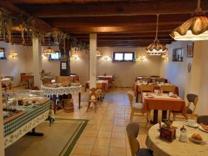 a restaurant with tables and chairs in a room at Hôtel Winzenberg bed and breakfast in Blienschwiller