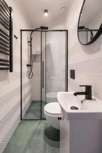 a bathroom with a shower and a toilet and a sink at Delis Apartments - Dluga Street 11/3 in Krakow