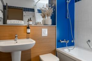 a bathroom with a sink and a toilet and a shower at Hotel Admiral Lugano in Lugano